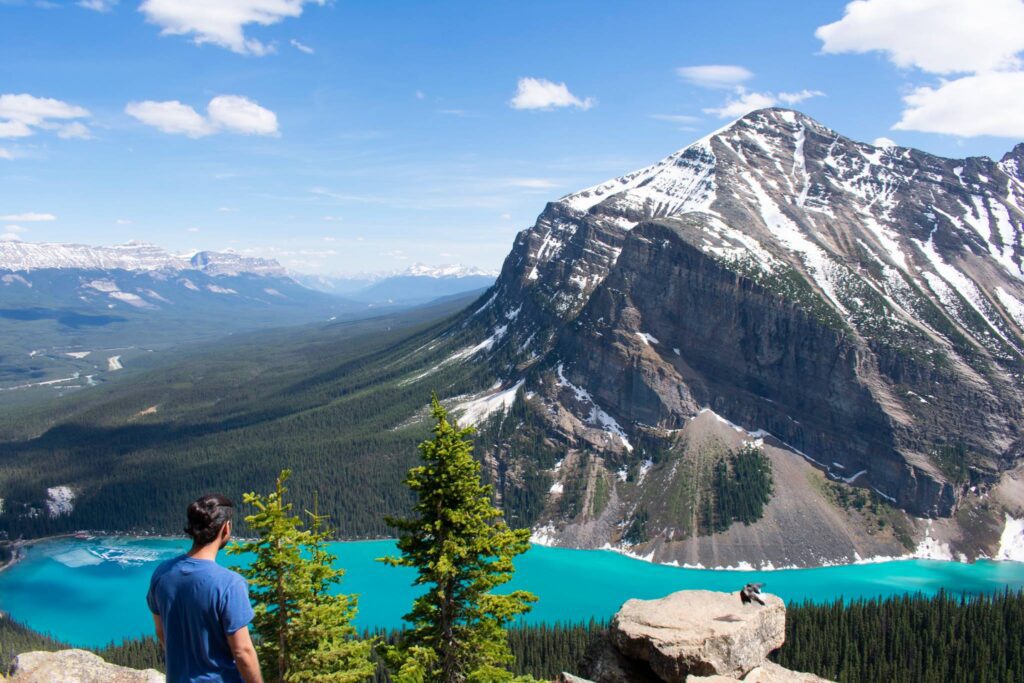 Member using Canoo to explore Canada in front of mountains and a blue lake.Canoo Members spotlight Embracing Culture and Acts of Kindness: The Inspiring Journey of Aditya Ahuja