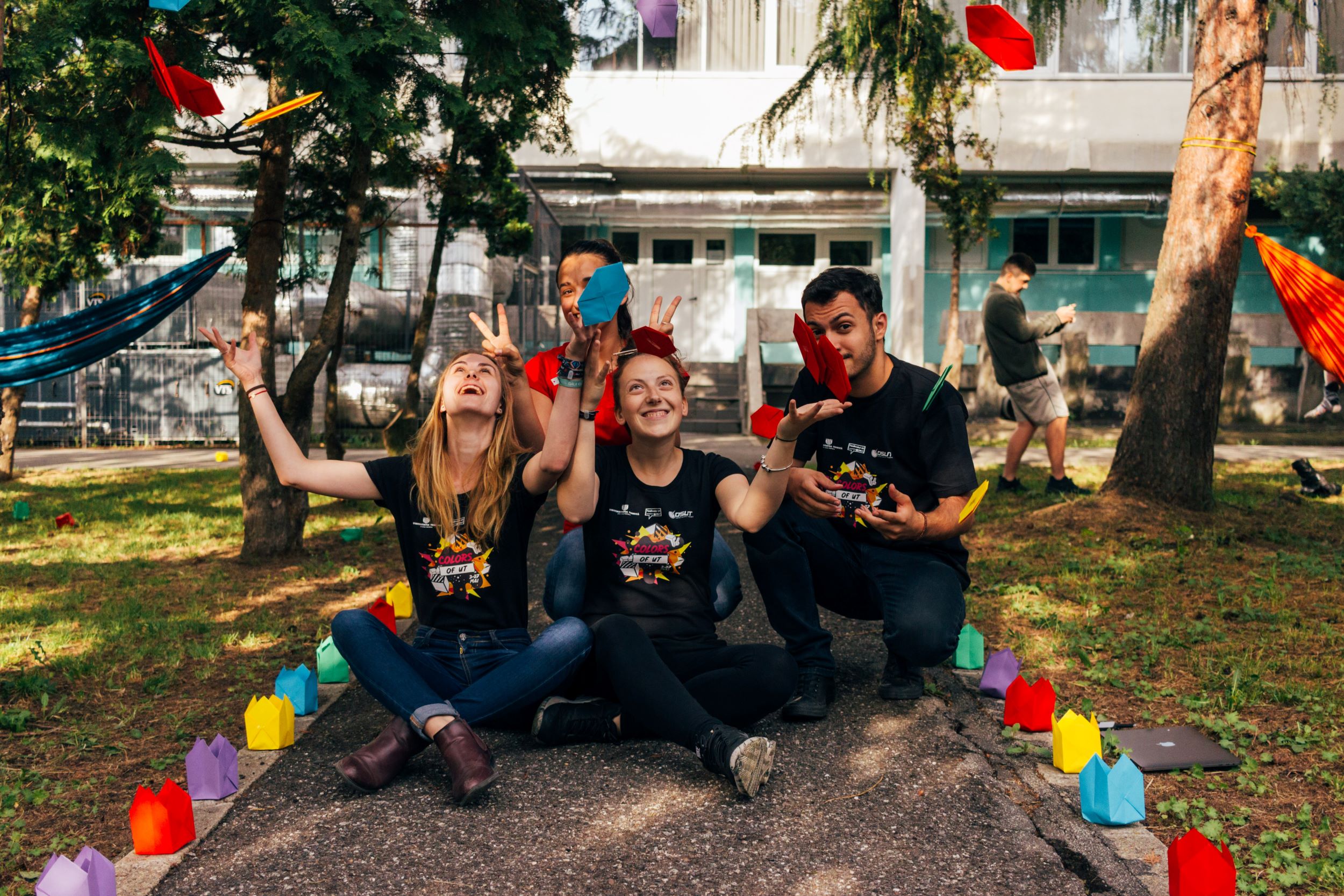 Photo of volunteers throwing pieces of paper into the air.