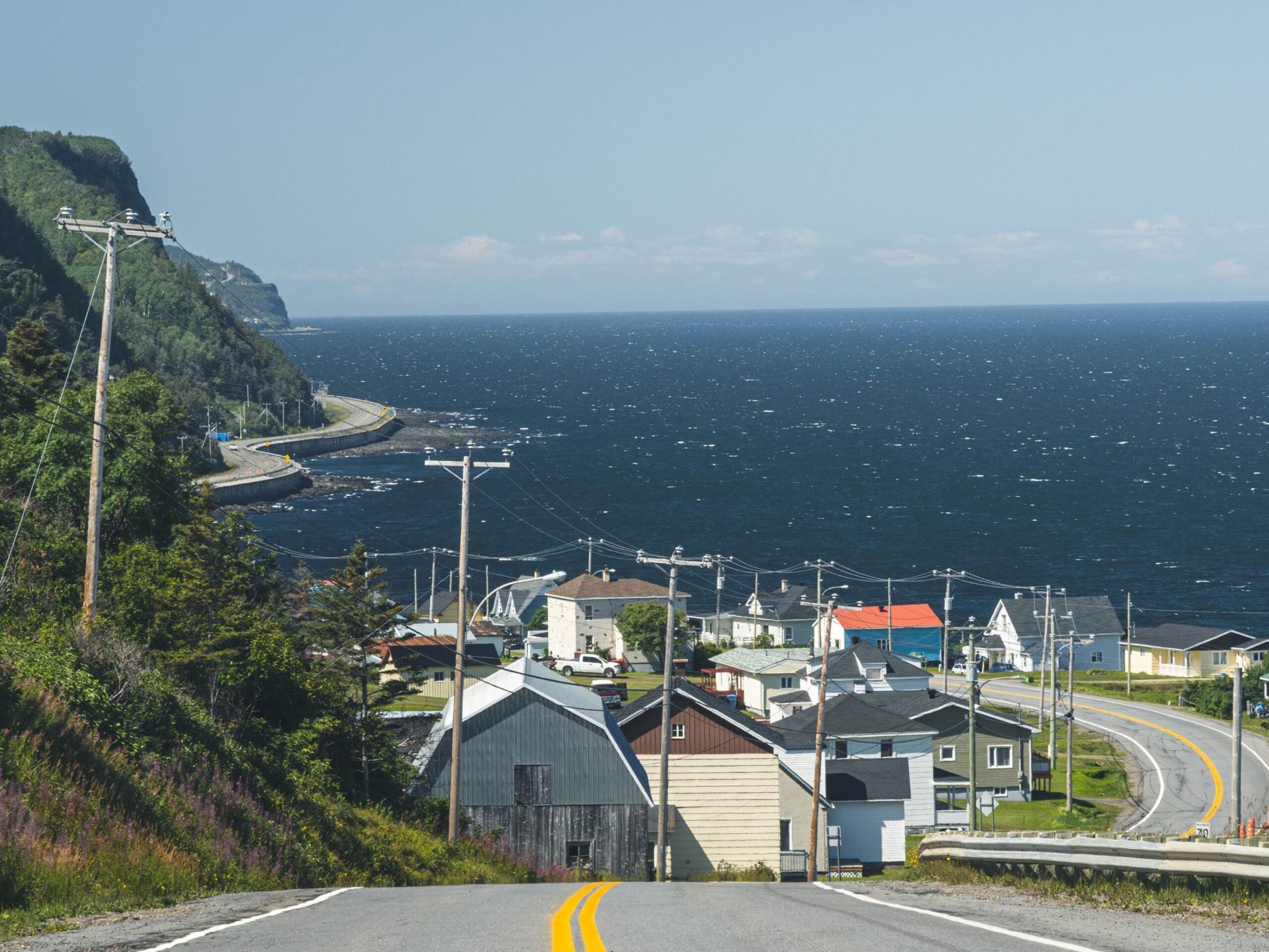 Image from the top of a hill overlooking buildings and water in Quebec.