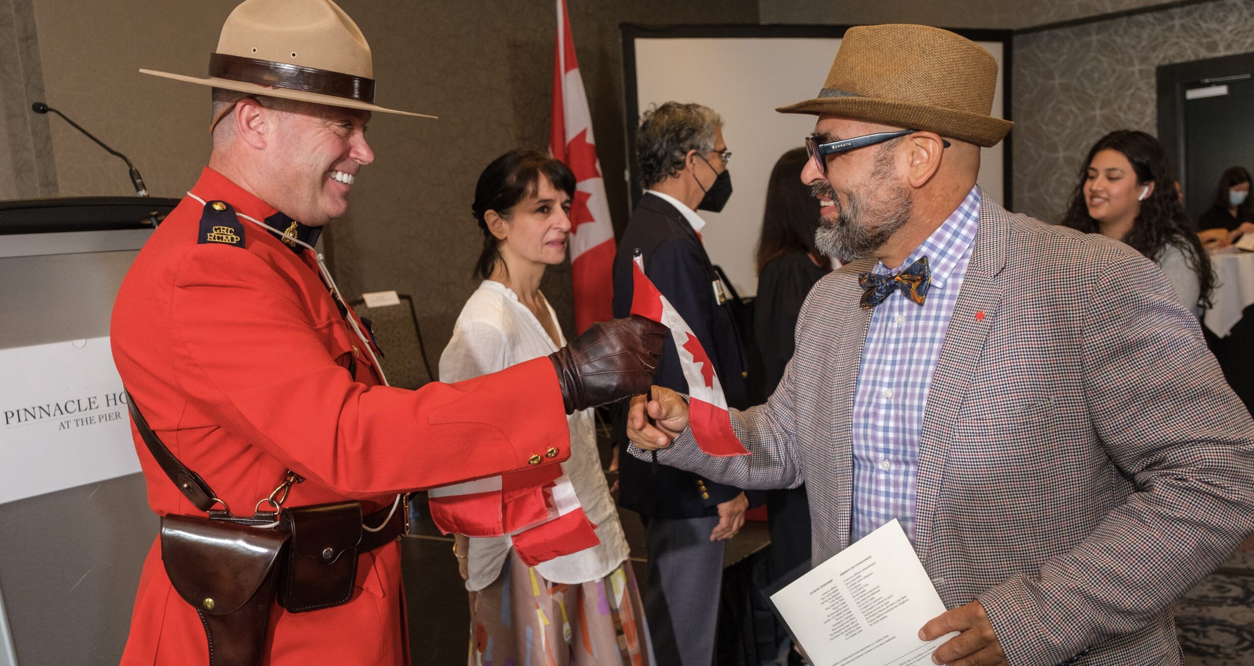 New Canadian receiving their citizenship at a Canadian citizenship ceremony.