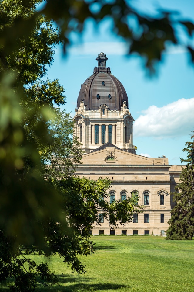 A building with a dome and trees in front of it.