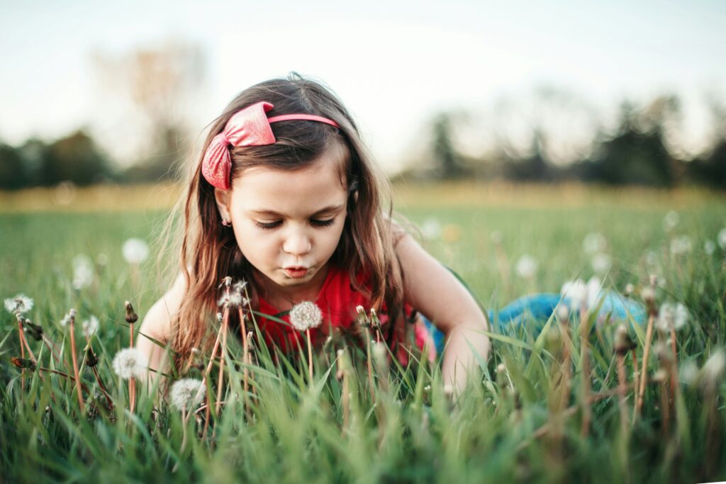 A child without allergies playing in the grass.