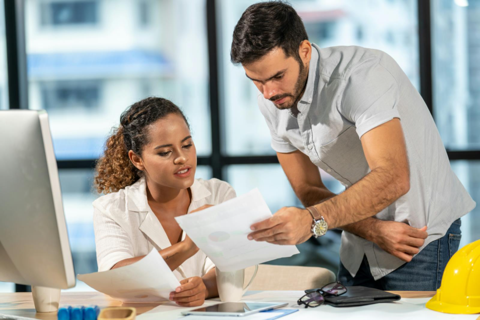 Image of people reviewing documentation before sending money.