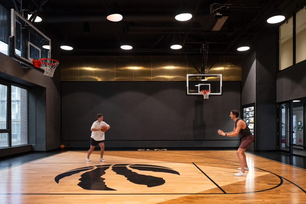 Two people playing basketball inside a rental apartment.