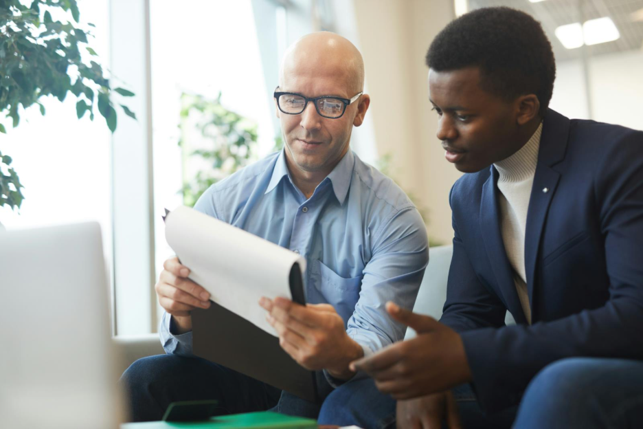 A financial advisor showing a customer their notes.